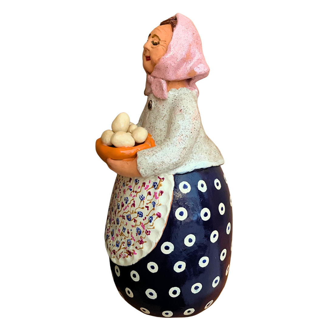 Hand-painted folk art babcia grannie figurine holding a bowl of fresh eggs
