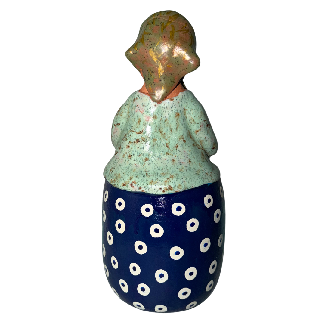 Hand-painted handcrafted babcia figurine holding a bowl of pierogi.