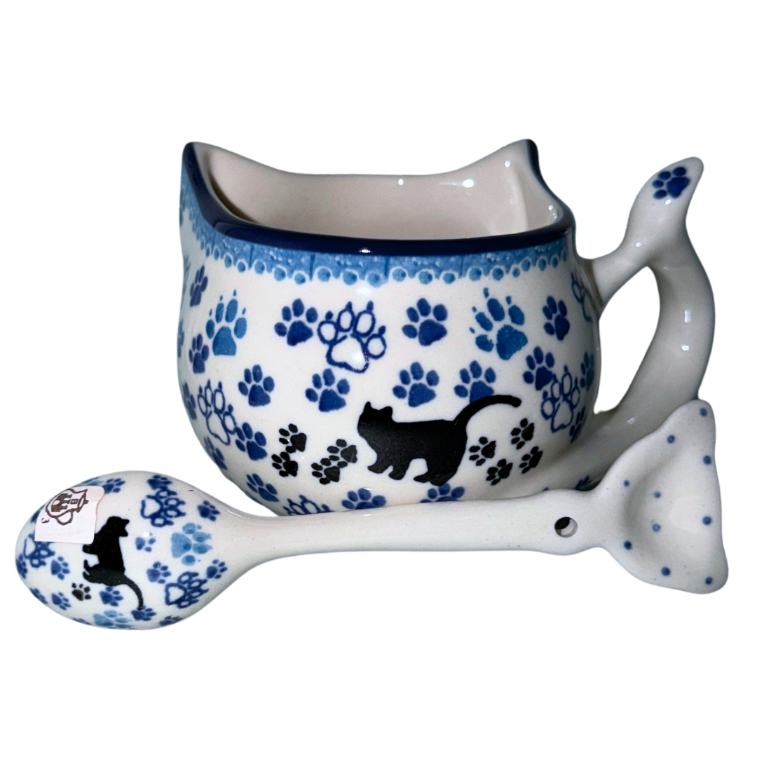 Ceramika Artystyczna Boo Boo Kitty 1771X Polish Pottery kitten cup and spoon set with black cat and blue paw prints, hand-painted in Bolesławiec, Poland.