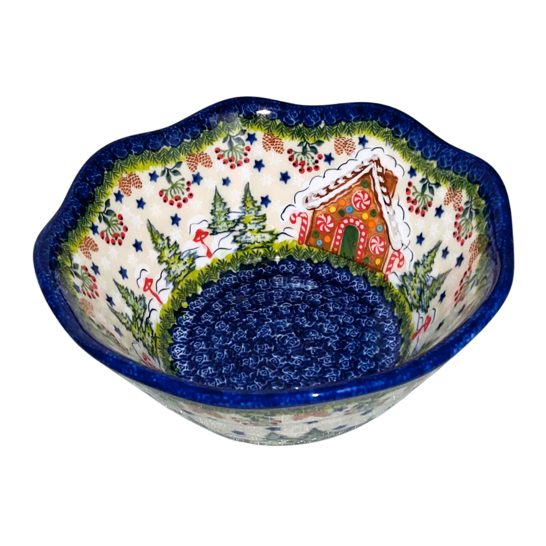 Hand-painted ceramic mug featuring a festive gingerbread cottage surrounded by evergreen branches, berries, and holiday stars. Durable, functional art—perfect for coffee,