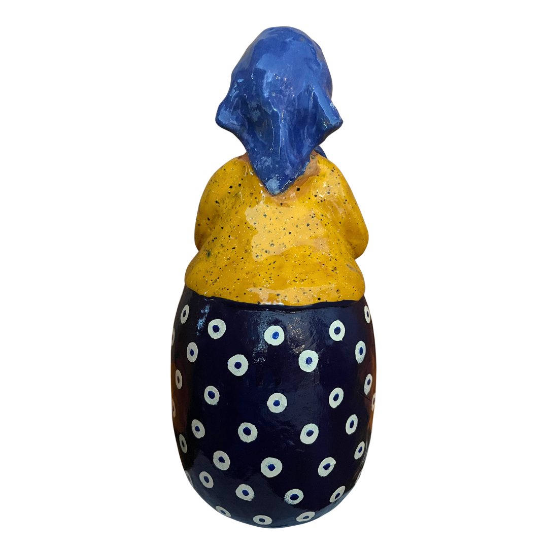 Hand-painted folk art babcia grannie figurine holding a bowl of fresh eggs