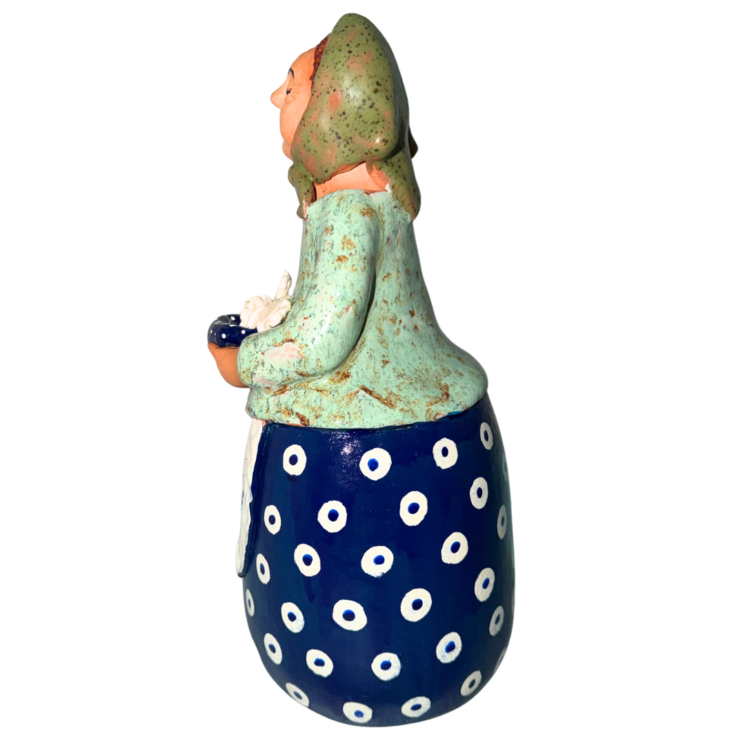 Hand-painted handcrafted babcia figurine holding a bowl of pierogi.