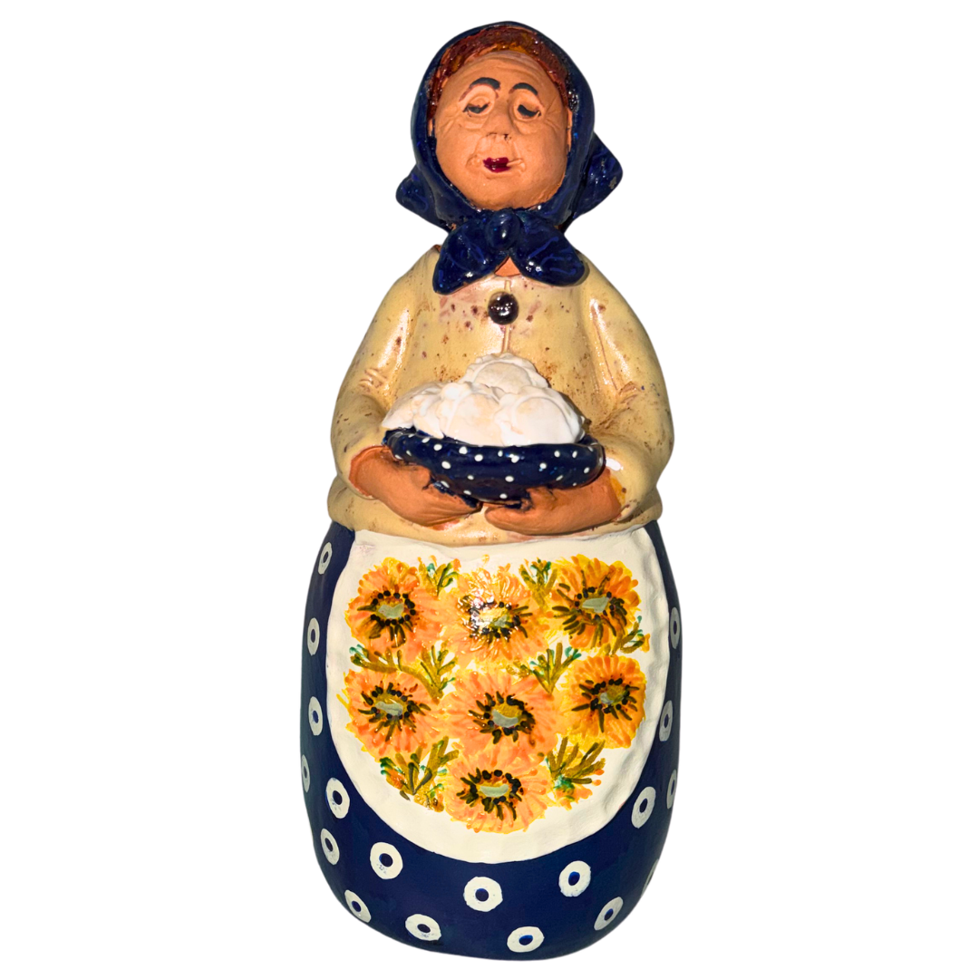Hand-painted handcrafted babcia figurine holding a bowl of pierogi.