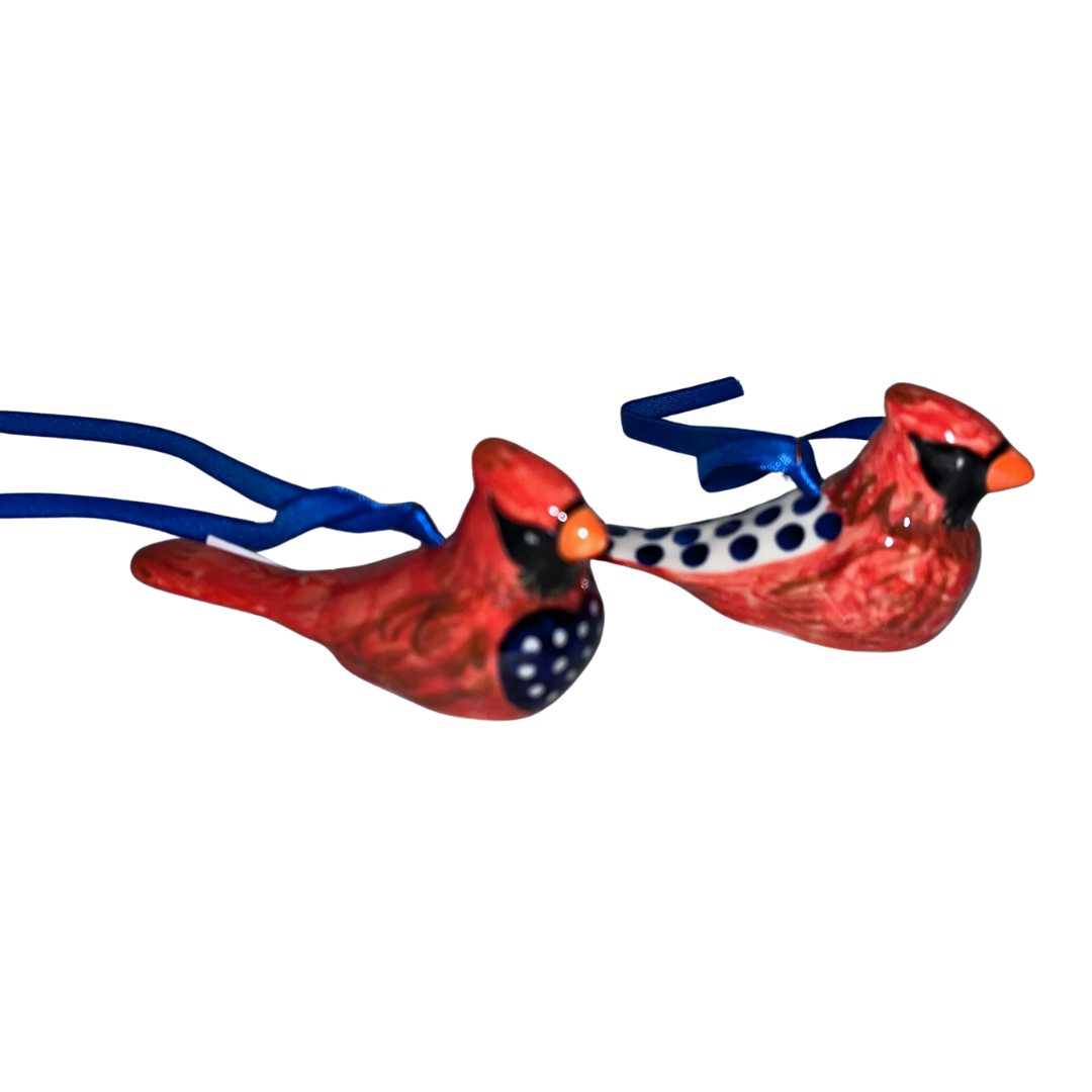 Handcrafted set of two Kalich cardinal ornaments featuring vibrant red and blue folk-art details. Perfect for holiday decorating and gifting.