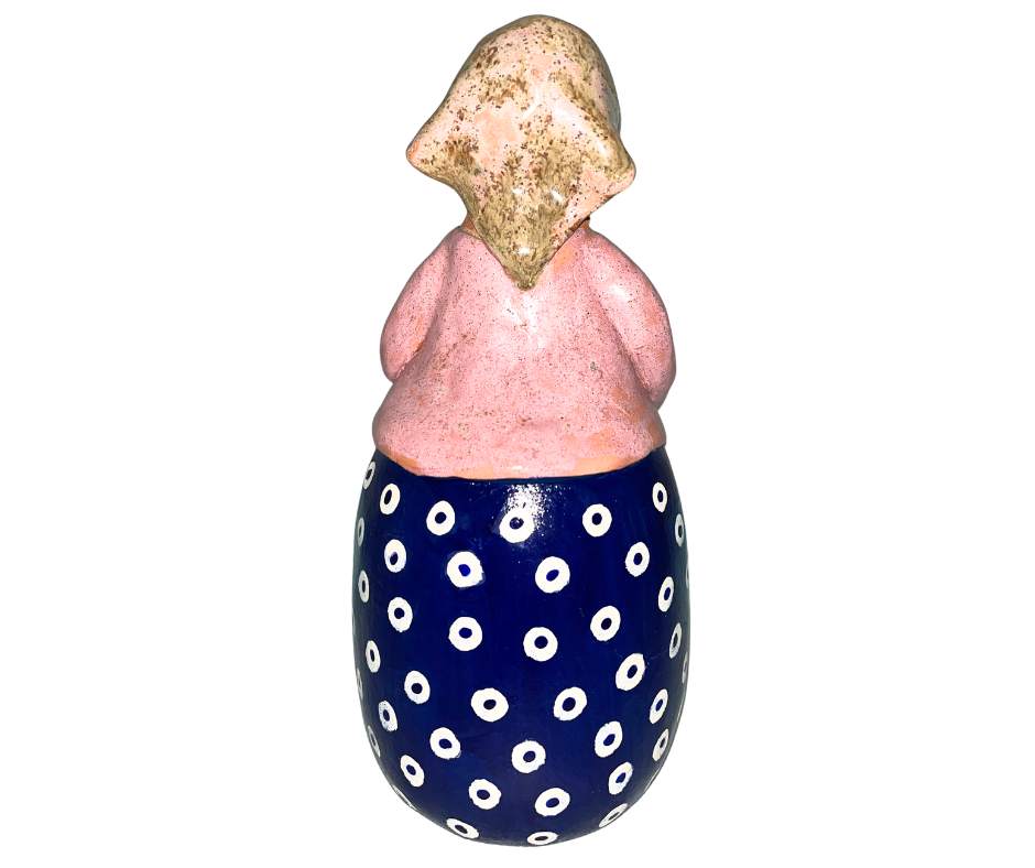 Hand-painted babcia figurine holding a bowl of pierogi, wearing a tan scarf and floral apron