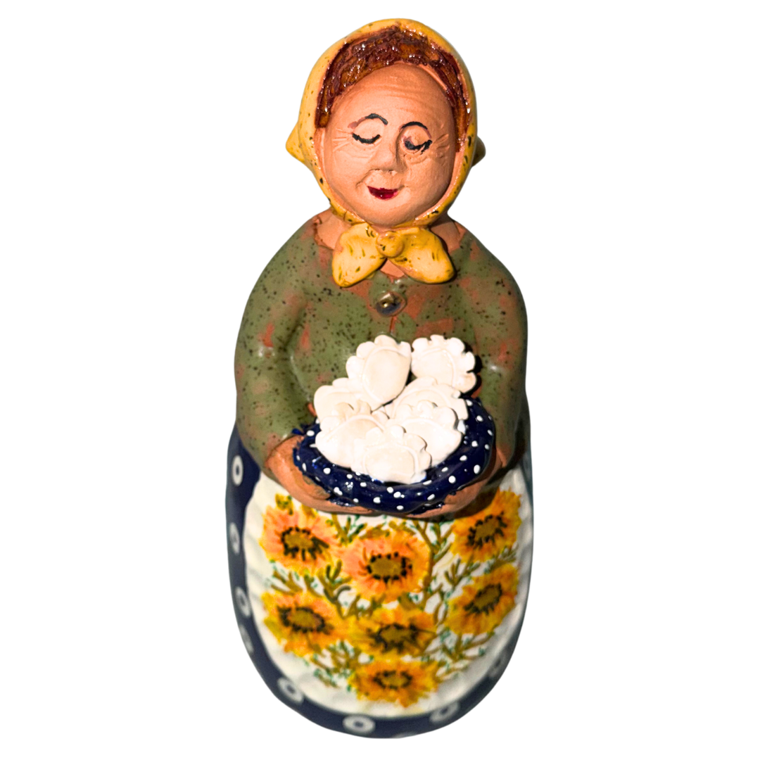 Hand-painted handcrafted babcia figurine holding a bowl of pierogi.