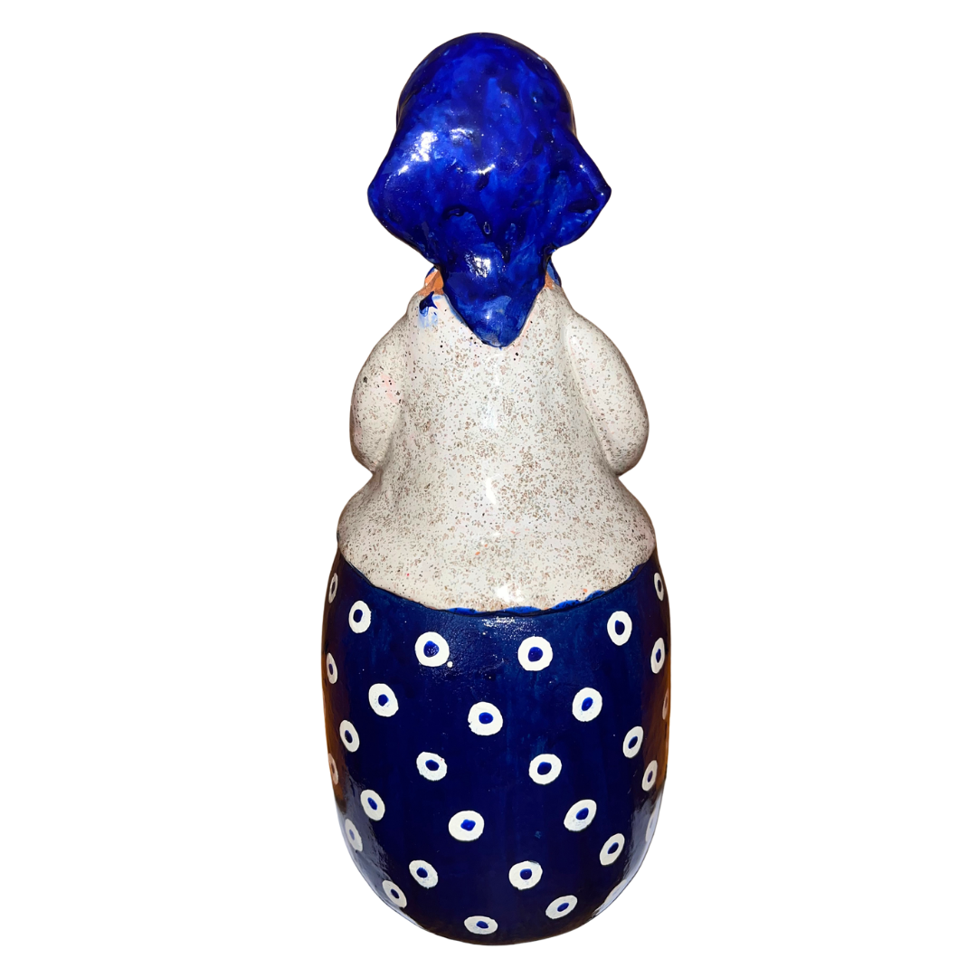 Charming hand-painted “Babcia Holding a Book” figurine featuring a Polish grandmother in an aqua scarf and floral apron. A heartwarming gift and beautiful piece of folk-inspired home décor.