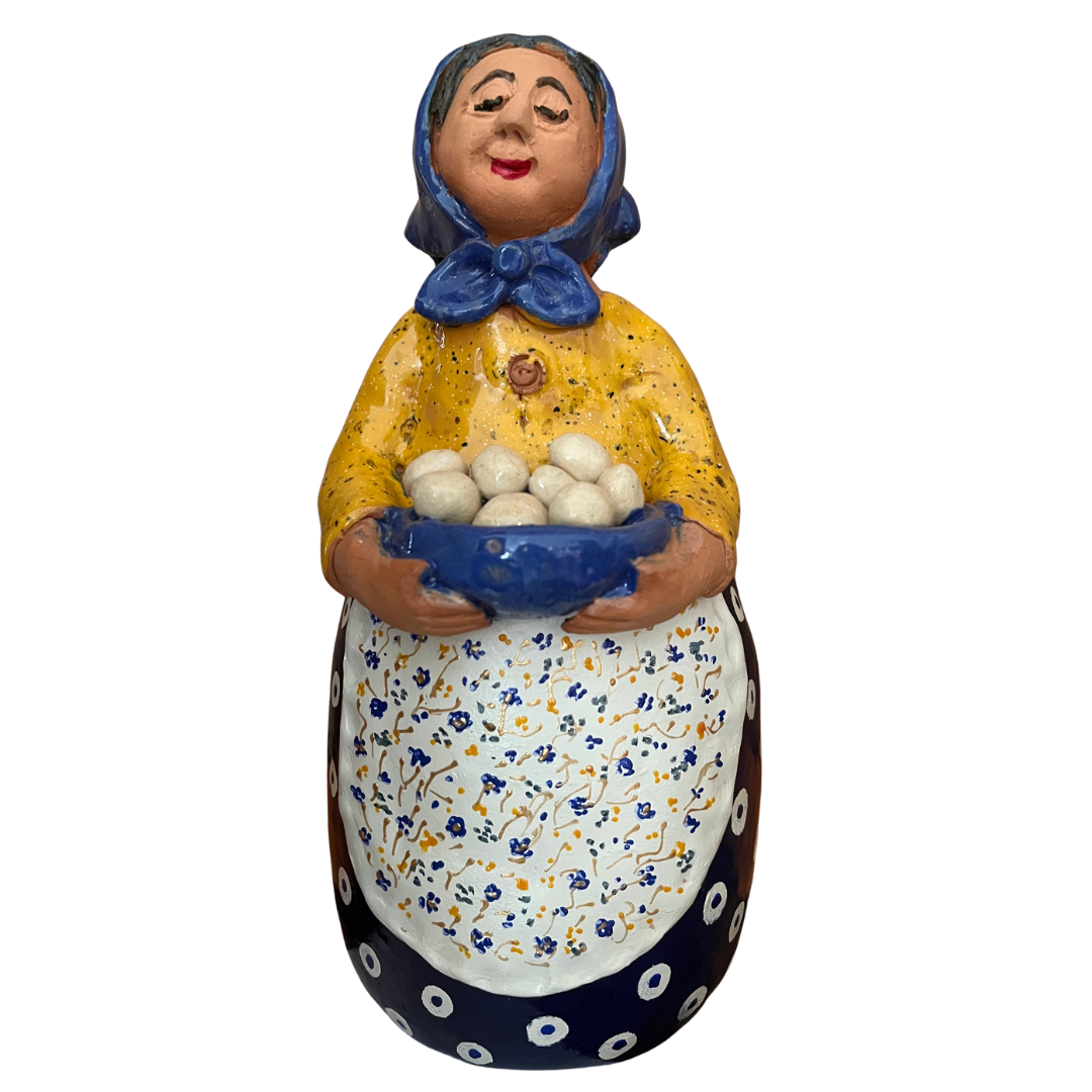 Hand-painted folk art babcia grannie figurine holding a bowl of fresh eggs