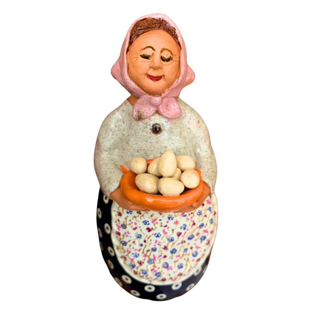 Hand-painted folk art babcia grannie figurine holding a bowl of fresh eggs
