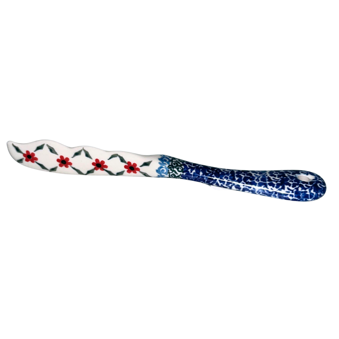 Ceramika Artystyczna Pattern 1494 Garden Trellis features red blossoms, green lattice vines, and cobalt blue borders. Handcrafted Polish pottery from Bolesławiec, Poland.