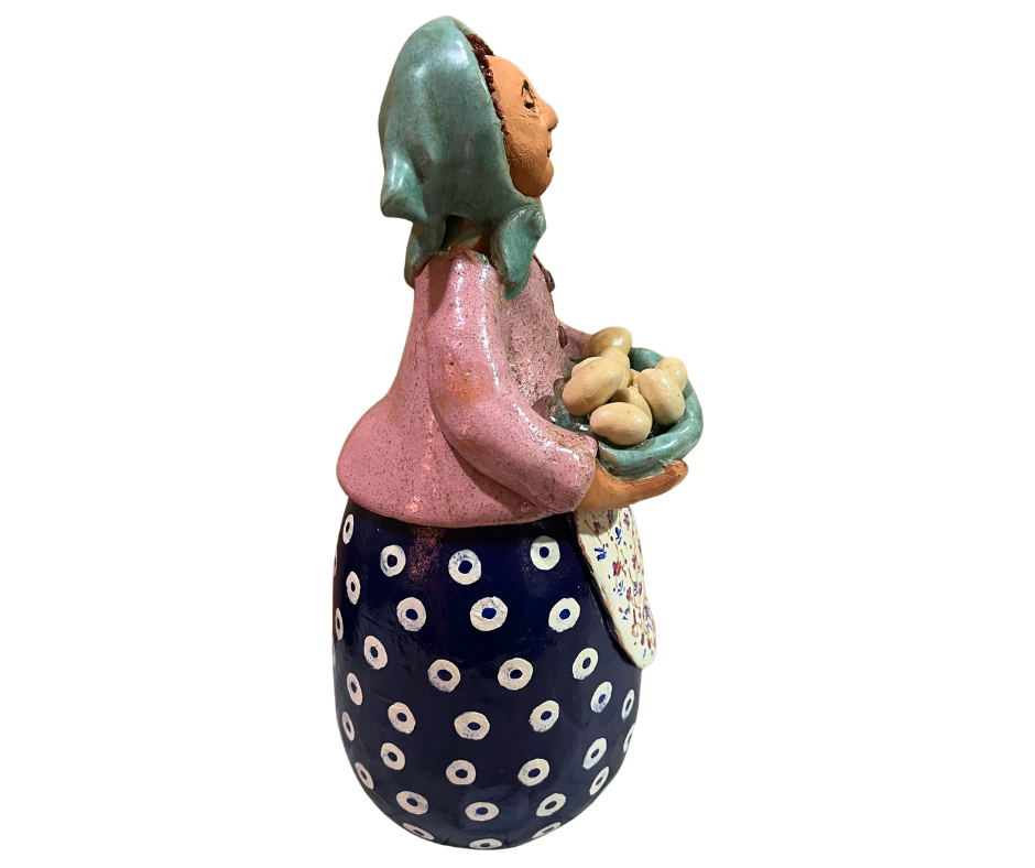 Hand-painted babcia grannie figurine holding a bowl of fresh eggs, wearing an aqua scarf and floral apron