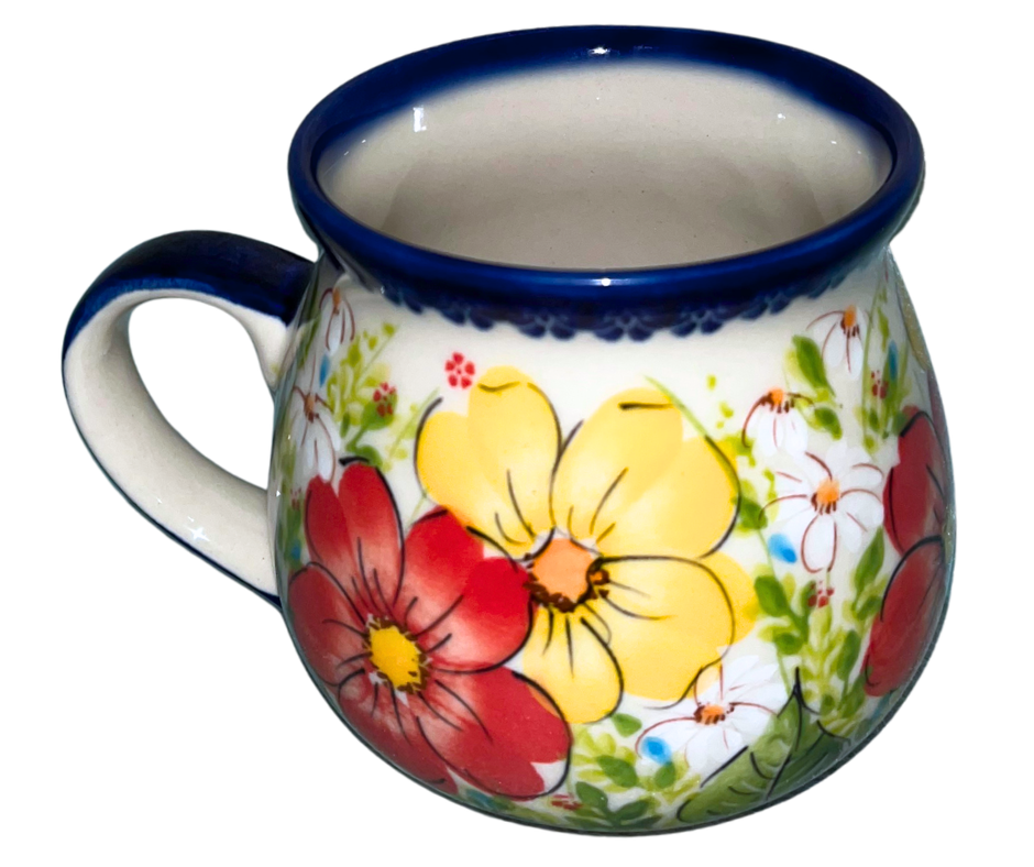Kalich Polish Pottery floral pattern with red and yellow blossoms, white accents, and green foliage on cream with cobalt rim; hand-painted meadow design with light, airy composition. (Copy)