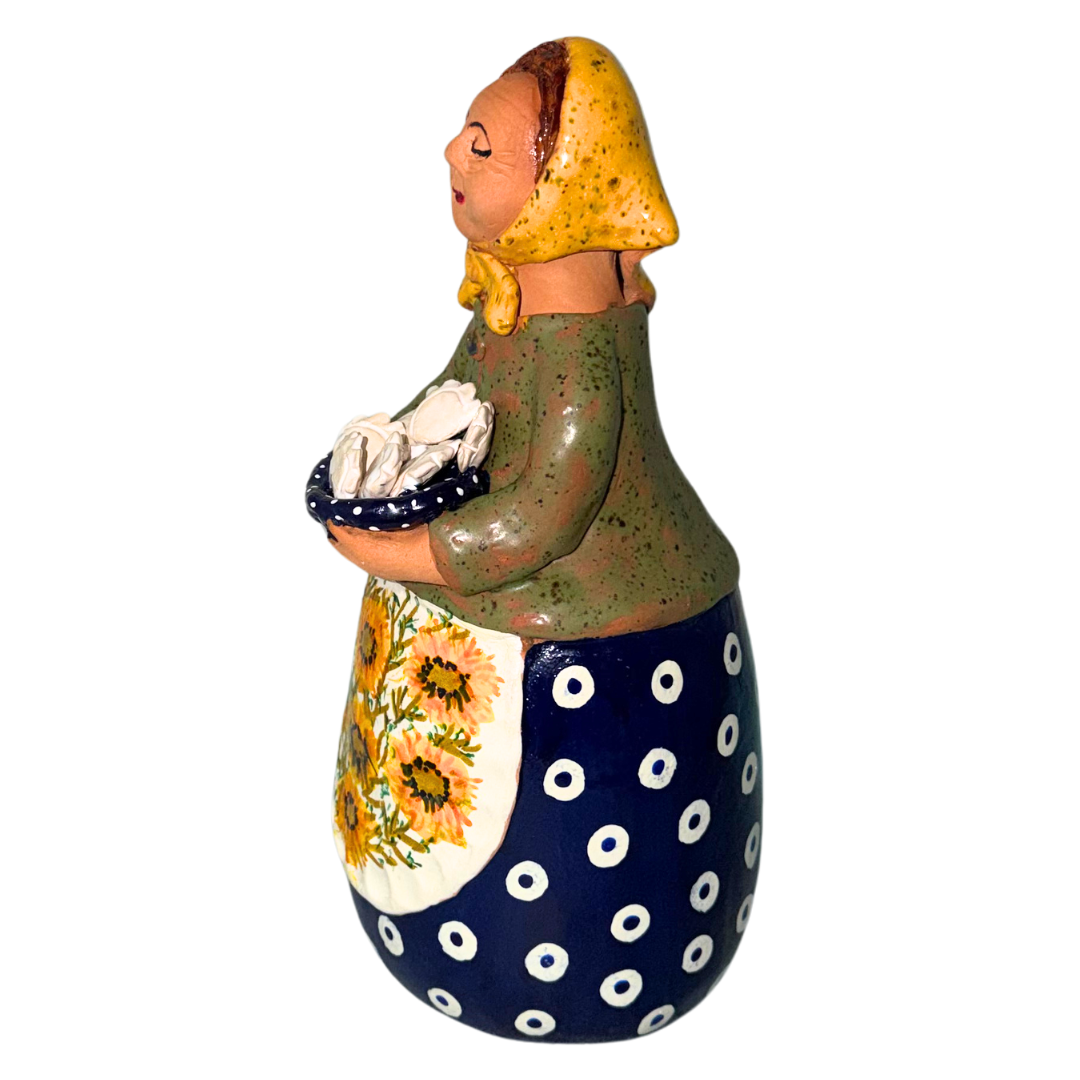 Hand-painted handcrafted babcia figurine holding a bowl of pierogi.