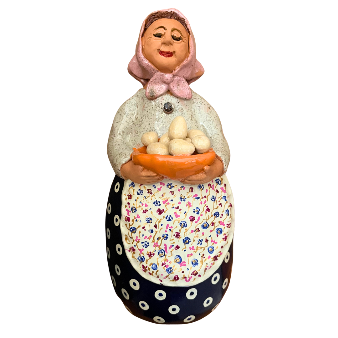 Hand-painted folk art babcia grannie figurine holding a bowl of fresh eggs