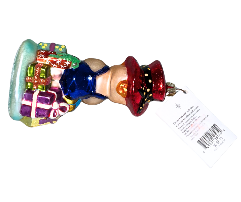 Christopher Radko “Gift of Health” #00-SP-73 hand-blown glass ornament featuring a child with gifts and red hat. Vintage collectible symbolizing care, wellness & holiday joy.