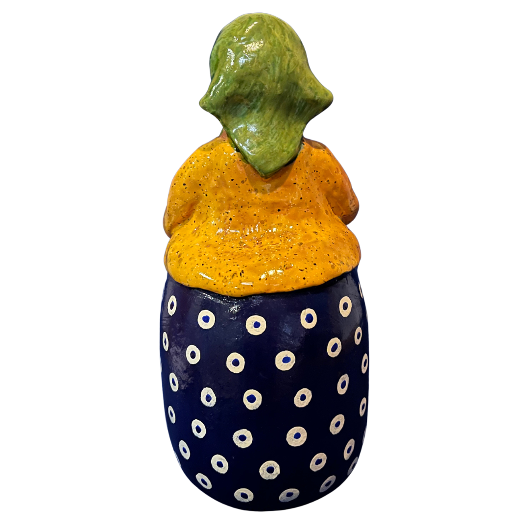 Hand-painted handcrafted babcia figurine holding a bowl of pierogi.
