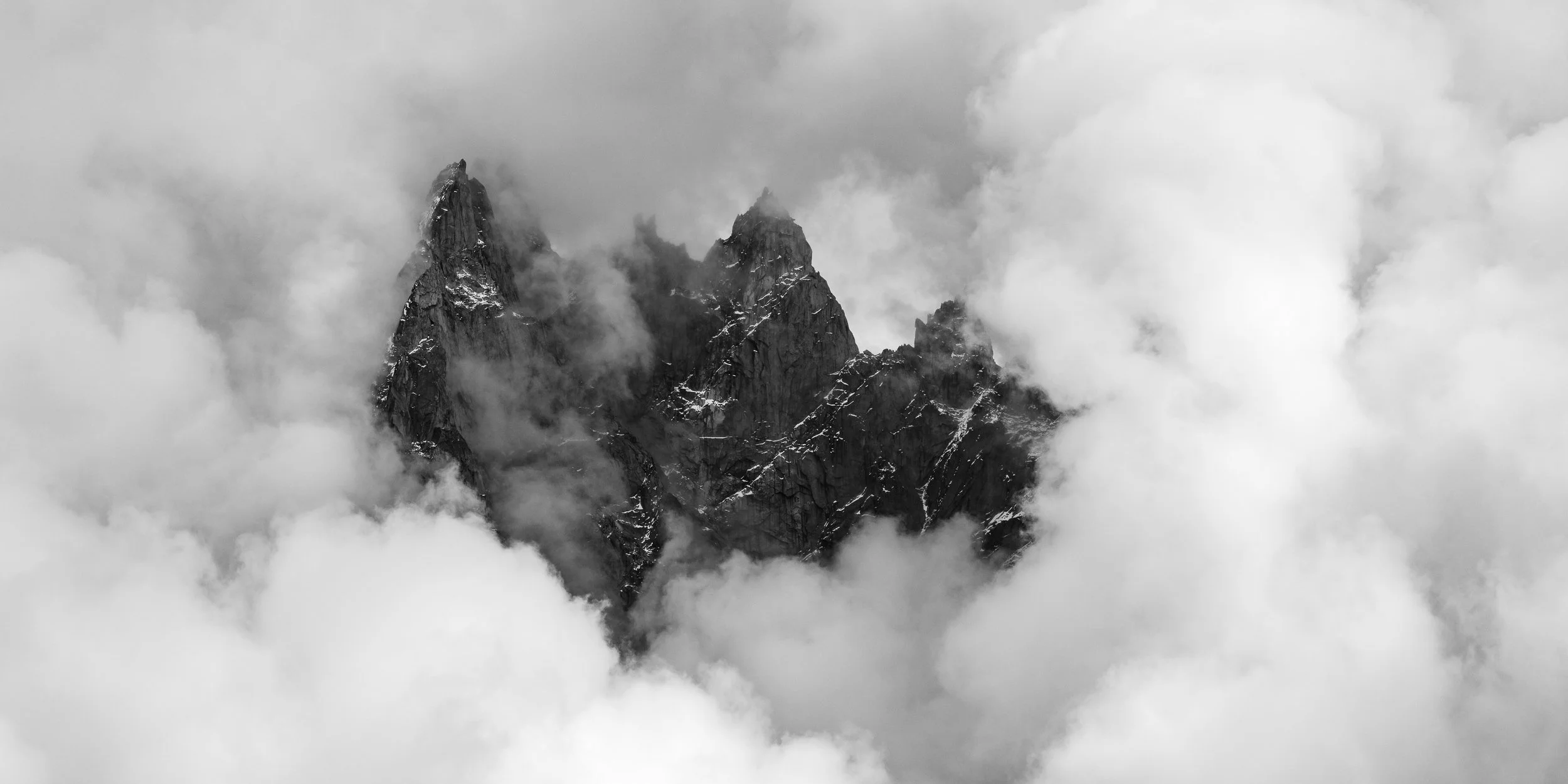Afternoon clouds surround Aiguille de Blaitière, Aiguille des Ciseaux and Aiguille du Fou in the Mont Blanc region of France. Image © Colin Henderson Photography. Permission required before use. To license this image, please contact me quoting the fi