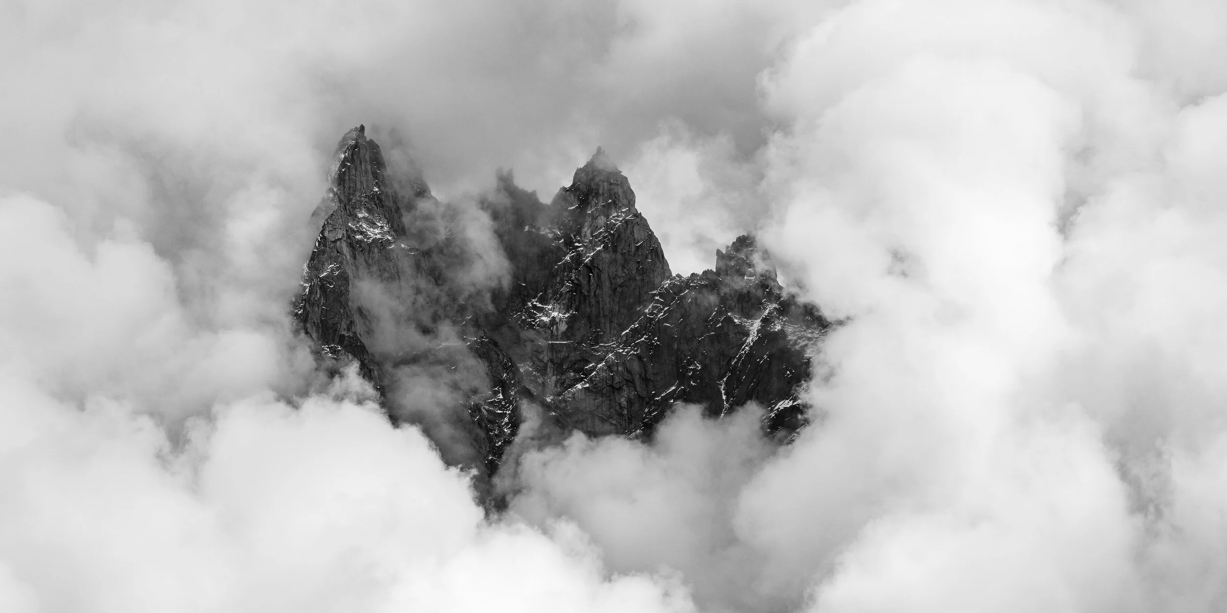 Afternoon clouds surround Aiguille de Blaitière, Aiguille des Ciseaux and Aiguille du Fou in the Mont Blanc region of France. Image © Colin Henderson Photography. Permission required before use. To license this image, please contact me quoting the fi