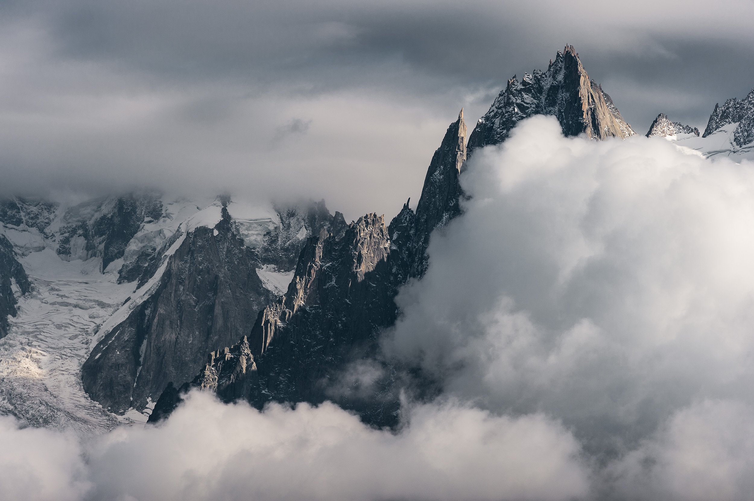 Afternoon clouds surround Aiguille de la République and Aiguille des Grands Charmoz above the town of Chamonix in France