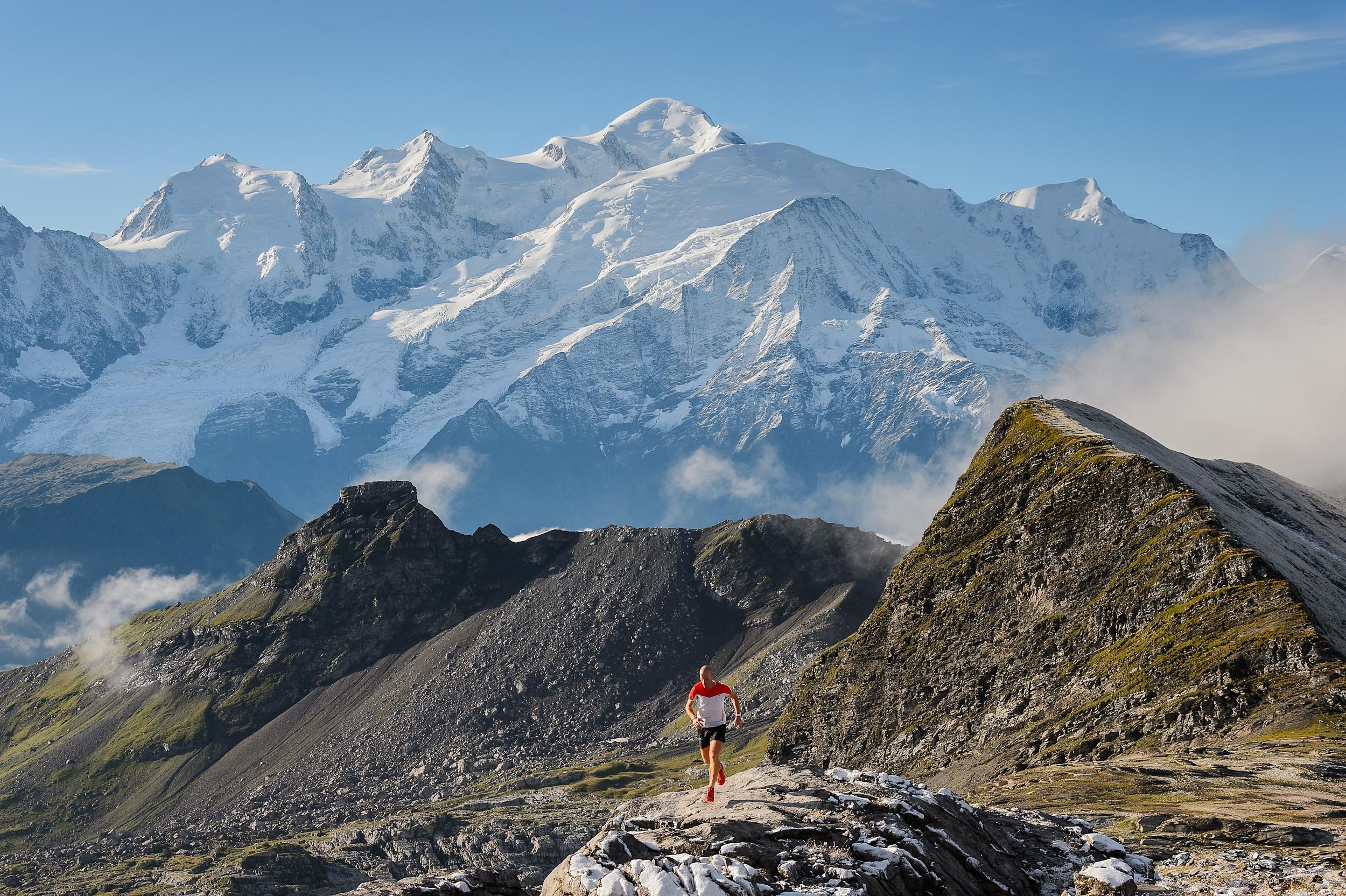 Scottish mountain runner and Salomon-sponsored athlete Donnie Campbell running on the rocks of Désert de Platé in front of Mont Blanc, France. 