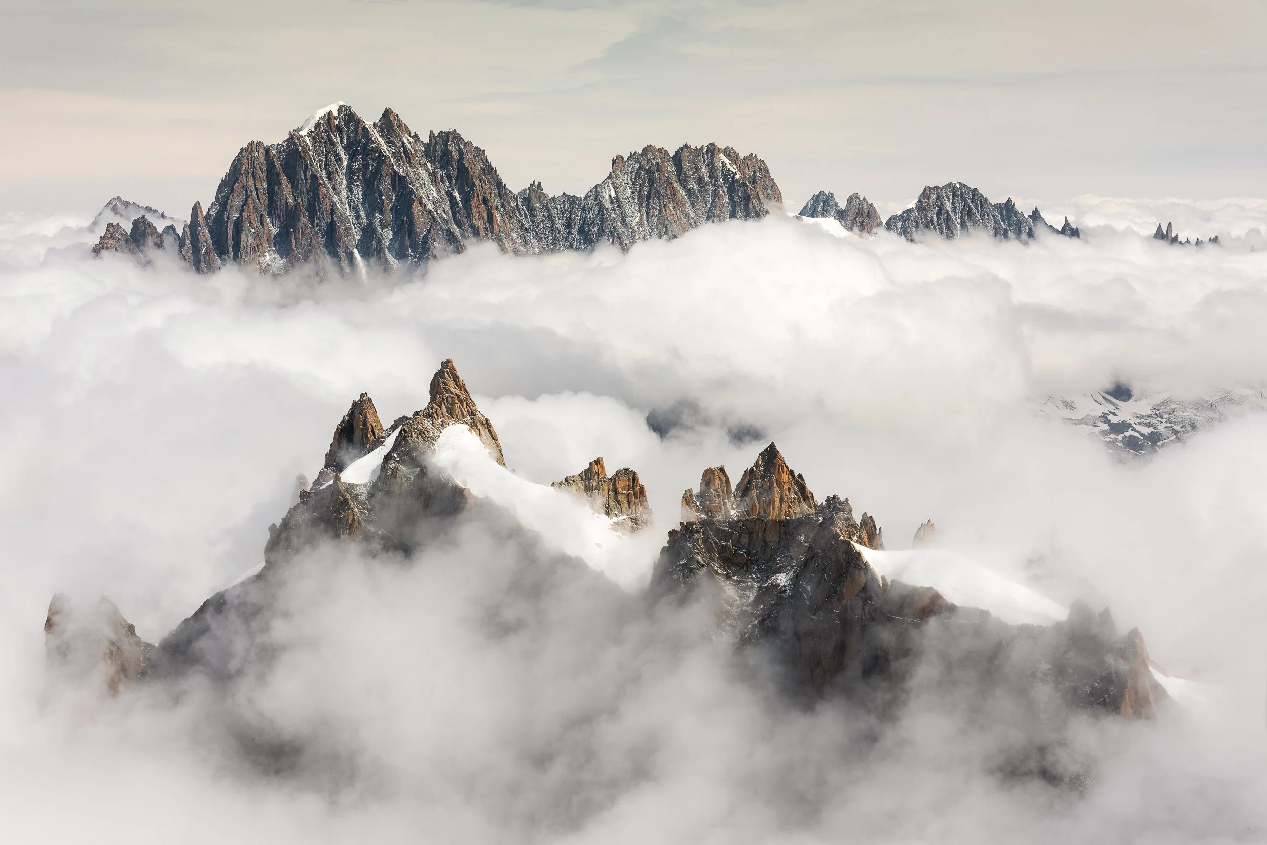 Looking over Aiguille du Plan to Aiguille Verte, Les Droites and Les Courtes from the tourist station on Aiguille du Midi above Chamonix, France. Image © Colin Henderson Photography. Permission required before use. To license this image, please conta