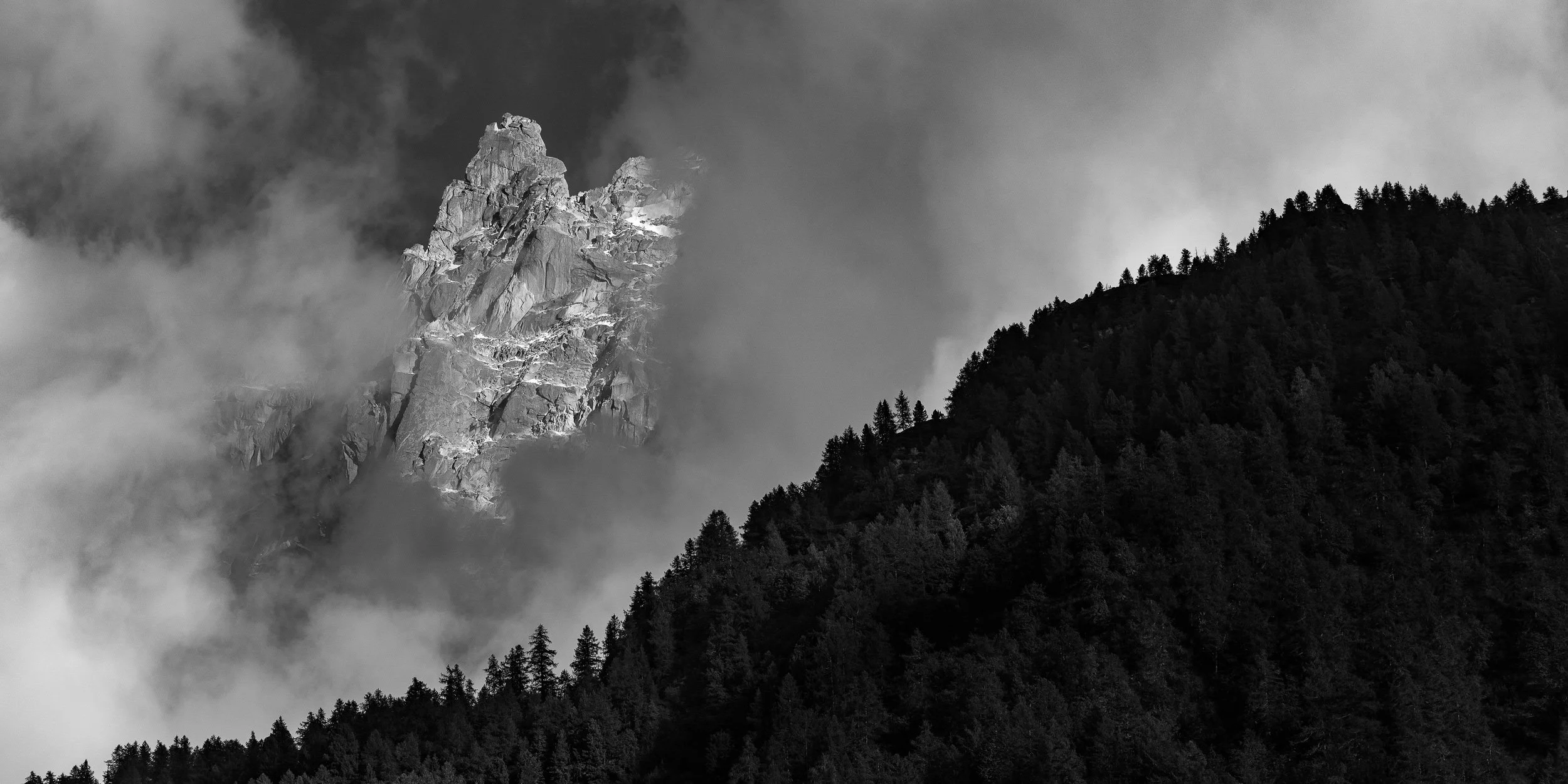 Dent du Caïman appearing out of the clouds in the Mont Blanc range of the European Alps