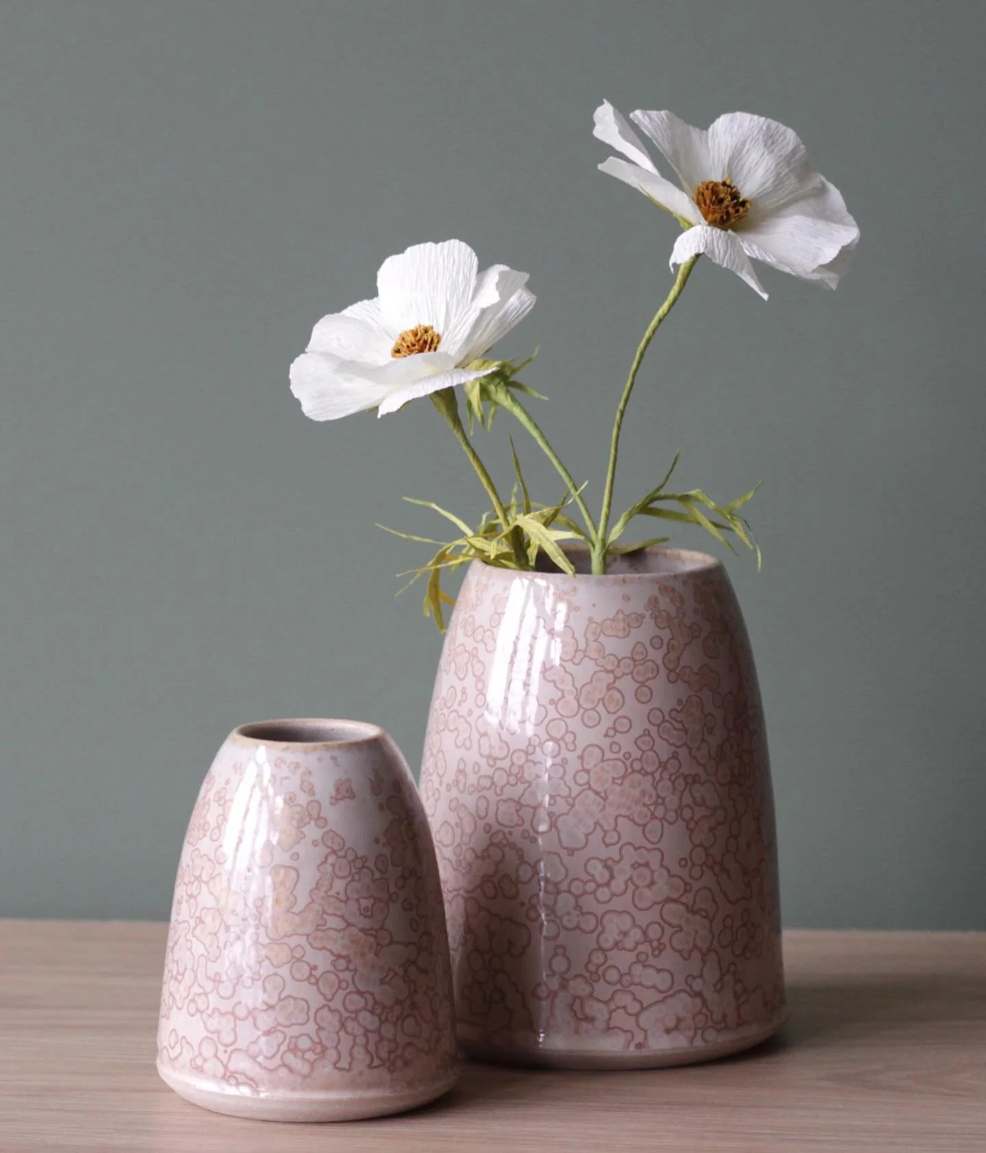 Thrown stoneware vases with shell pink crystalline glaze.

#studiopotter #handmadeceramics  #coastline