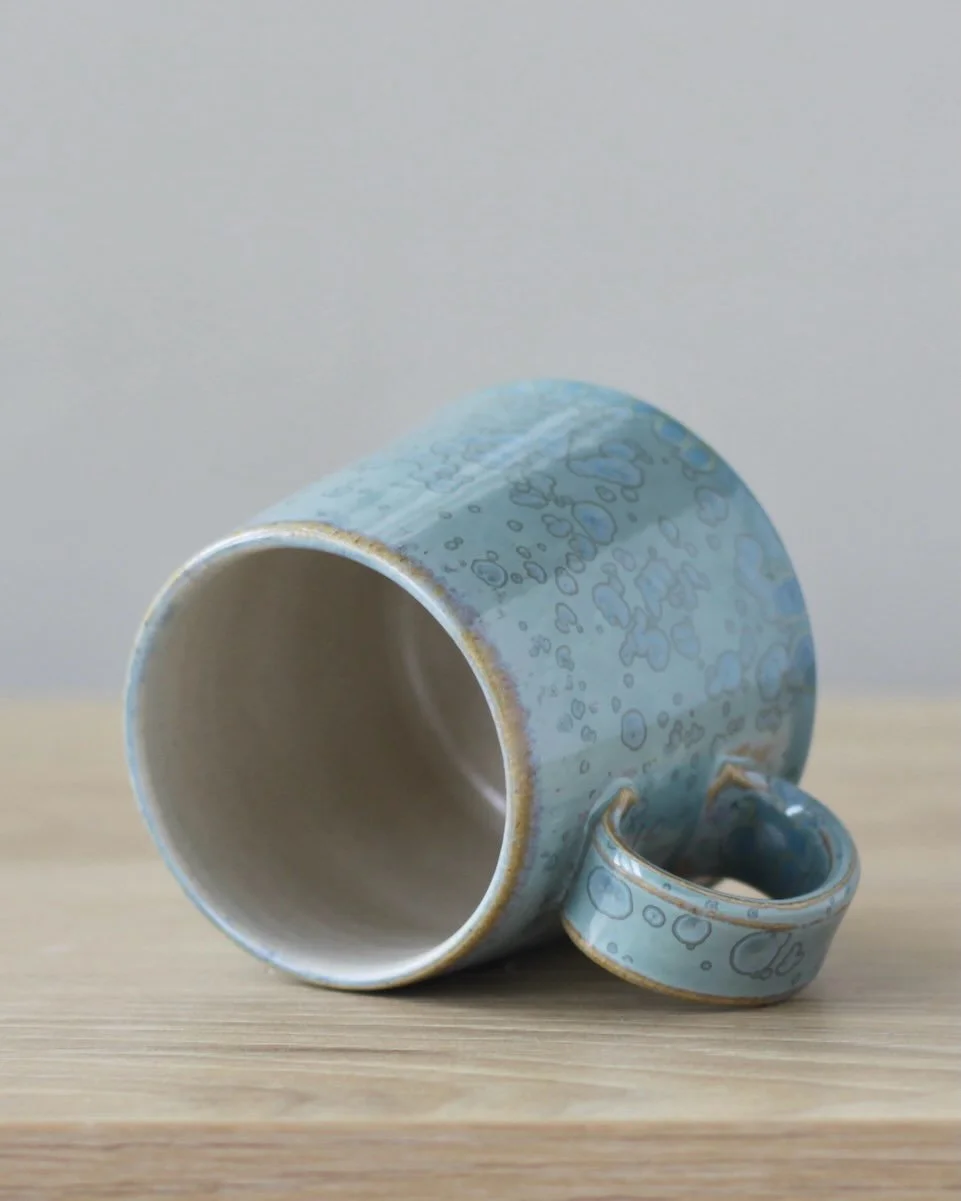 Stoneware mug with blue crystalline glaze.

8cm x 9cm