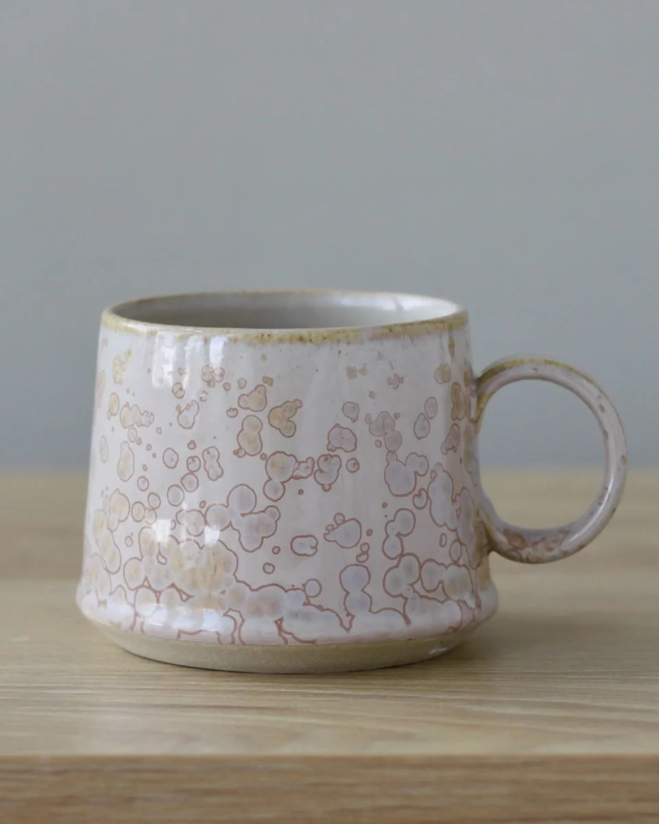 Pink crystalline glazed, stoneware mugs. 

7.5cm x 9.5cm
