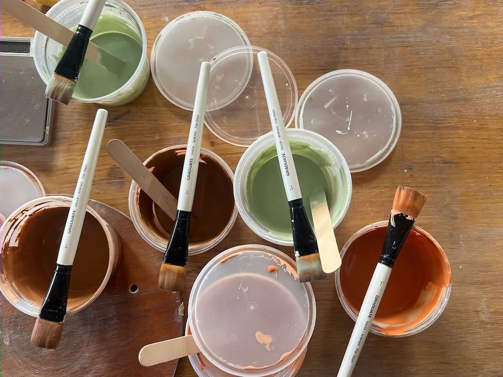 Pots-of-personally-formulated-brush-on-glaze-recipes-part-of-her-library-of-glaze-recipes