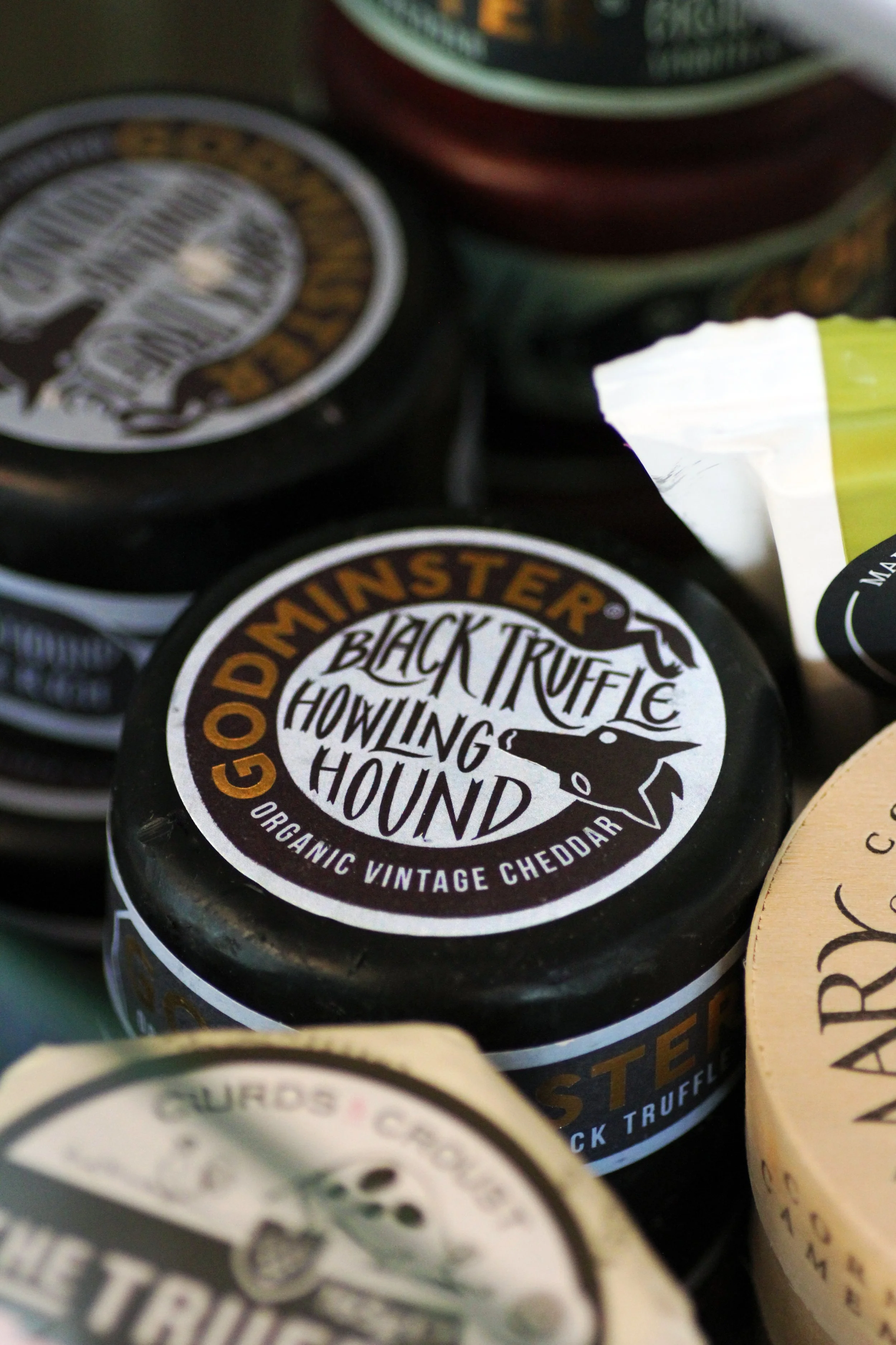 Round of Black Truffle Howling Hound cheddar cheese on display in Goggins and Grub, St. Agnes