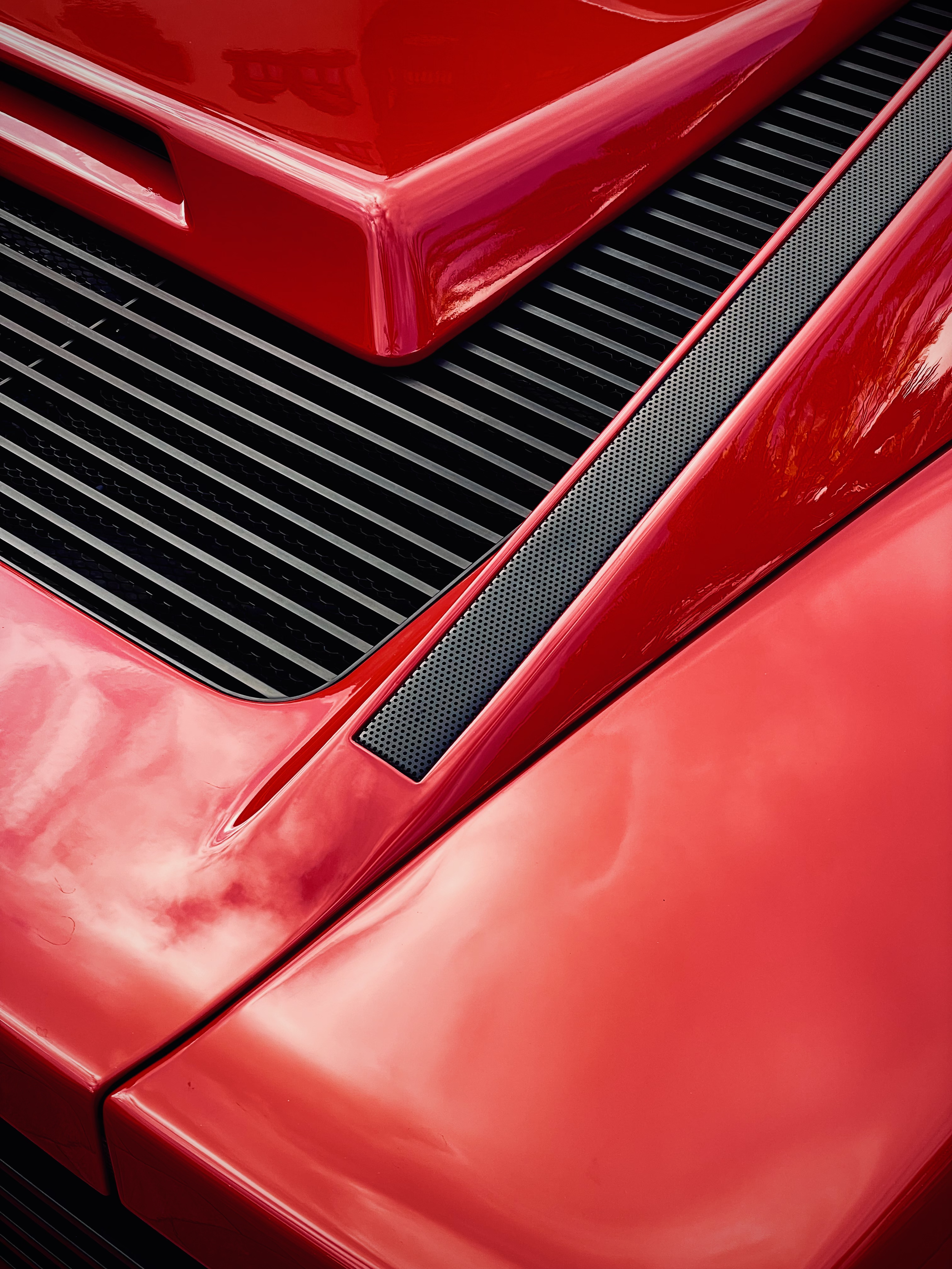 Close-up detail of the vent and bodywork of a red Ferrari Testarossa