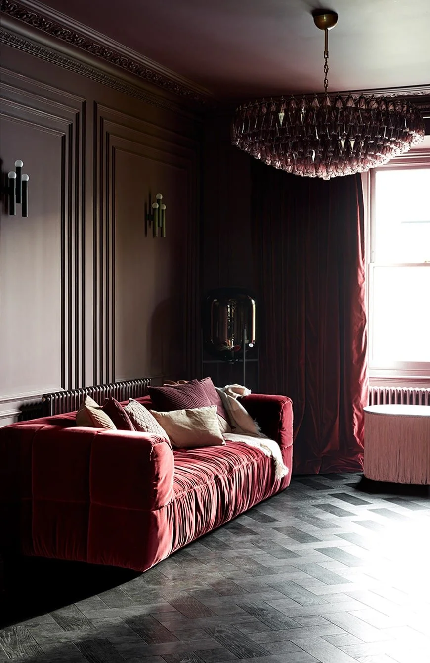 Post-completion living space within a renovated listed house, featuring a bold red and velvet interior palette