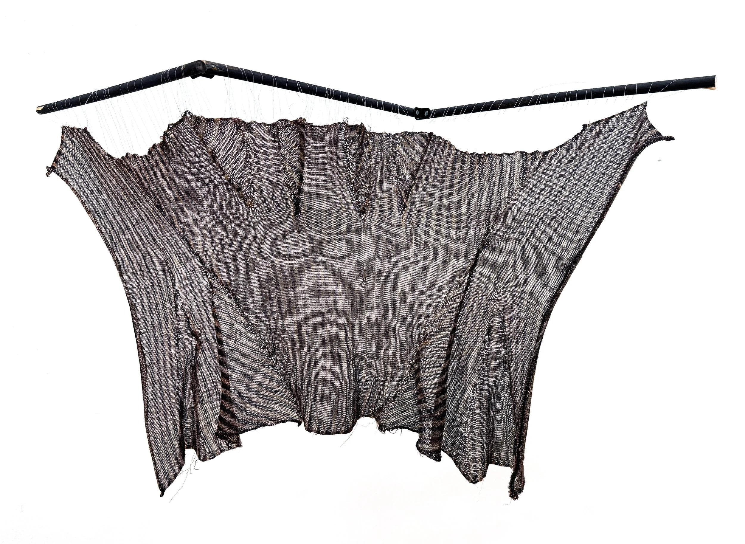 "Flatbed Stay." Deadstock merino wool, bundle-dyed silk yarn, and a grey and pink lurex. Knitting the stay horizontally and using partial knitting to knit the entire piece in one continuous knit and showing the original grainline directions of the st