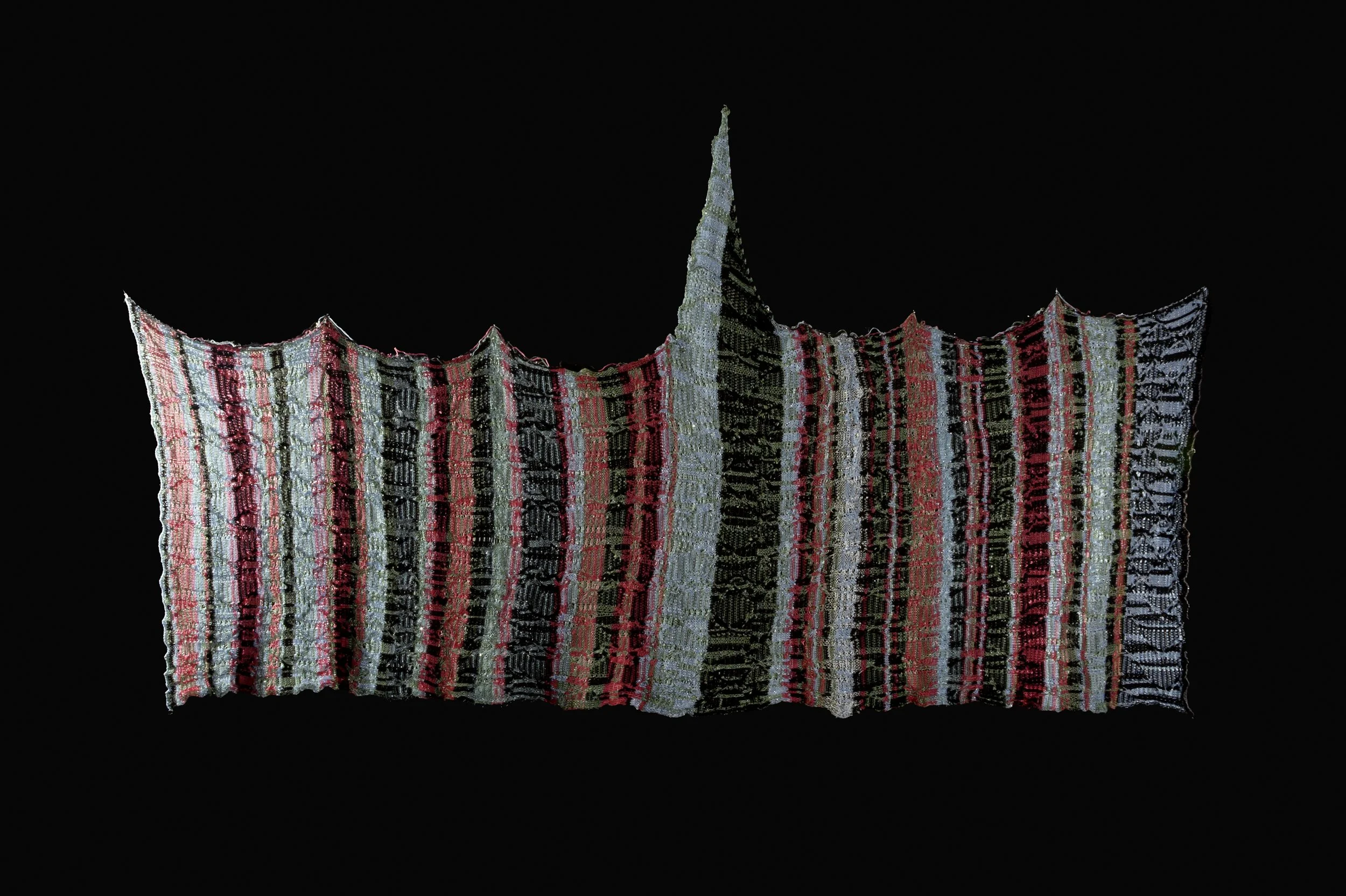"Double Jacquard.' Double jacquard knit with a custom punchcard going through four different vertical stripe patterns over 90 (180) rows. Cable pattern also developed from three different cable structures meshed together over the full pattern. All na