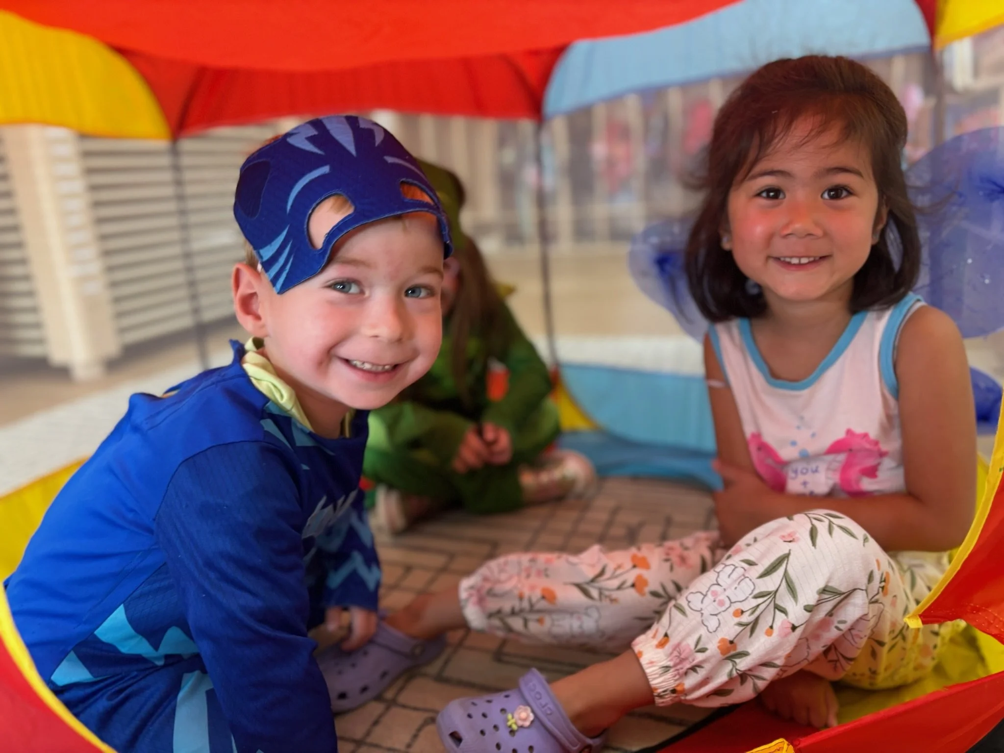 Two kids in a play tent