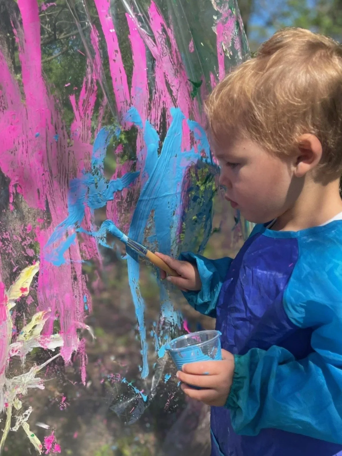 Little boy painting.