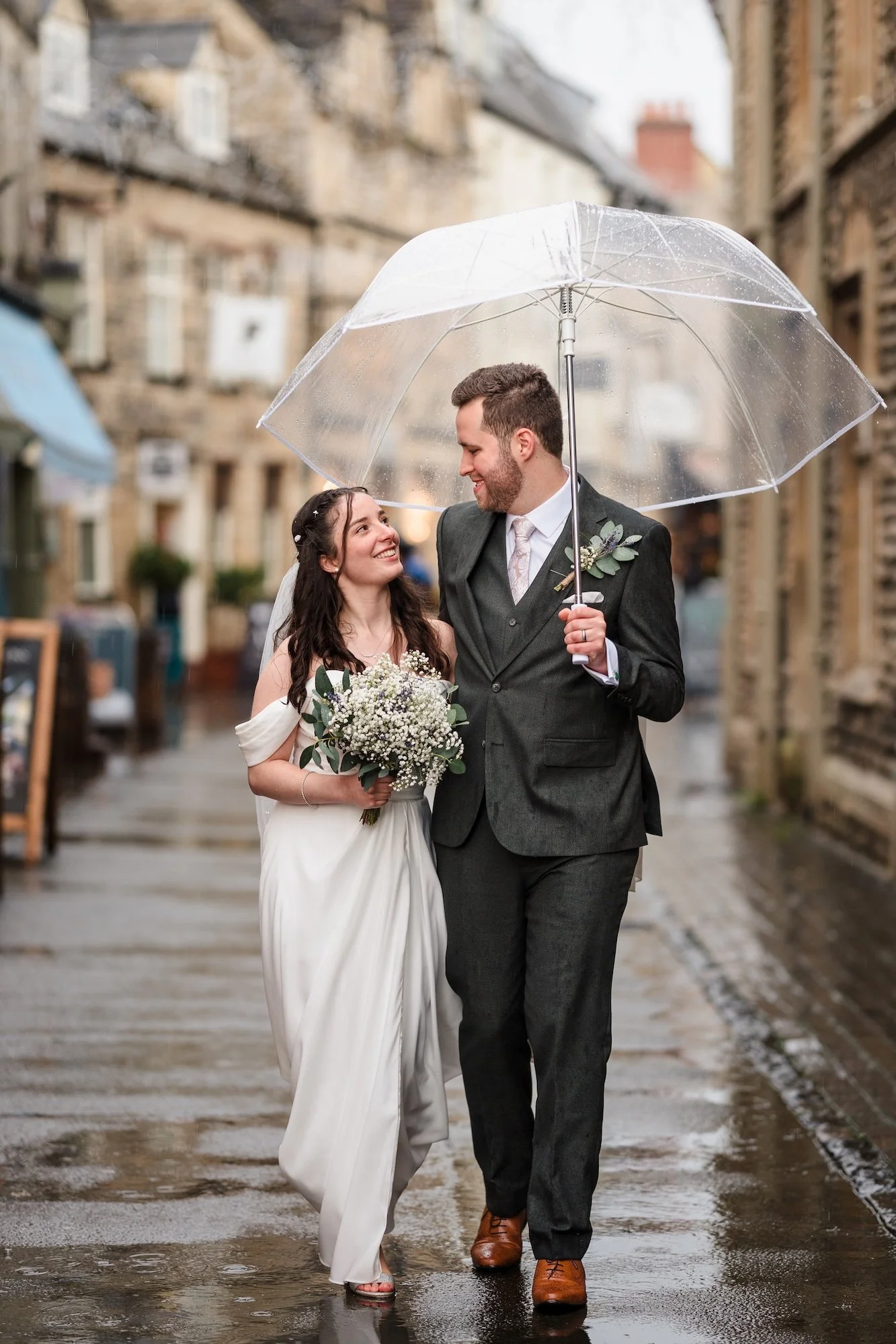 Bride and Groom Walking Cotswolds street of Cirencester