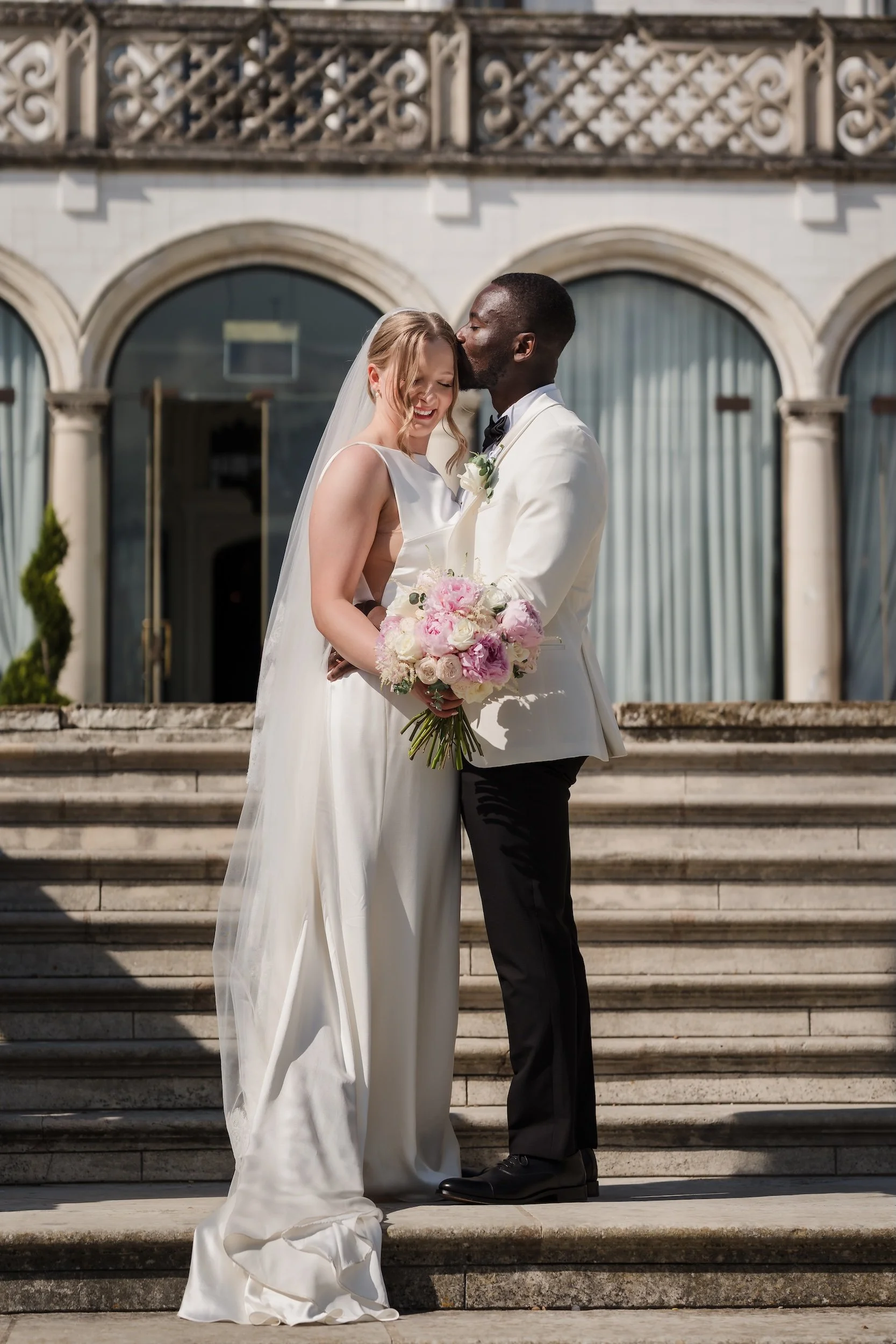 Bride and Groom Kiss outside Danesfield house.jpg