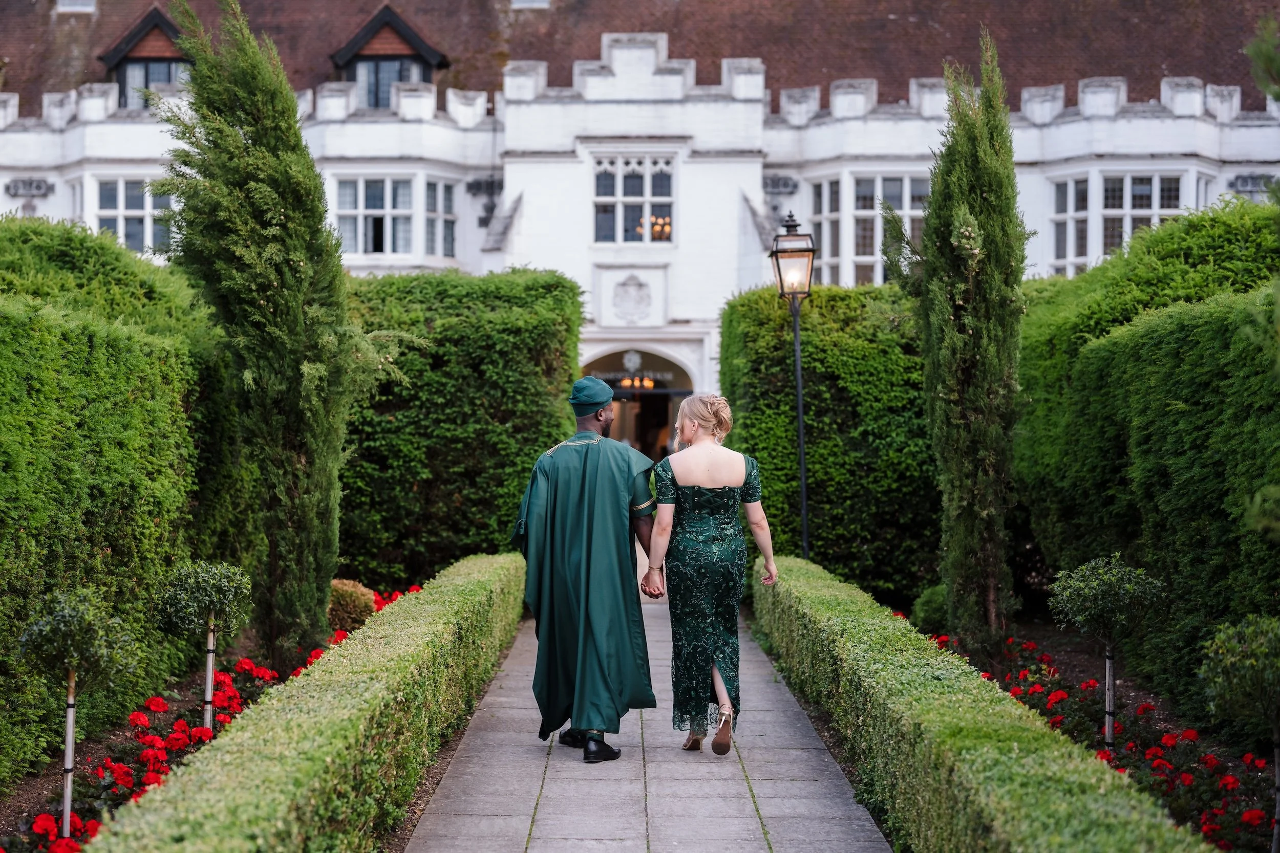 Danesfield house wedding bride and groom walking in garden.jpg