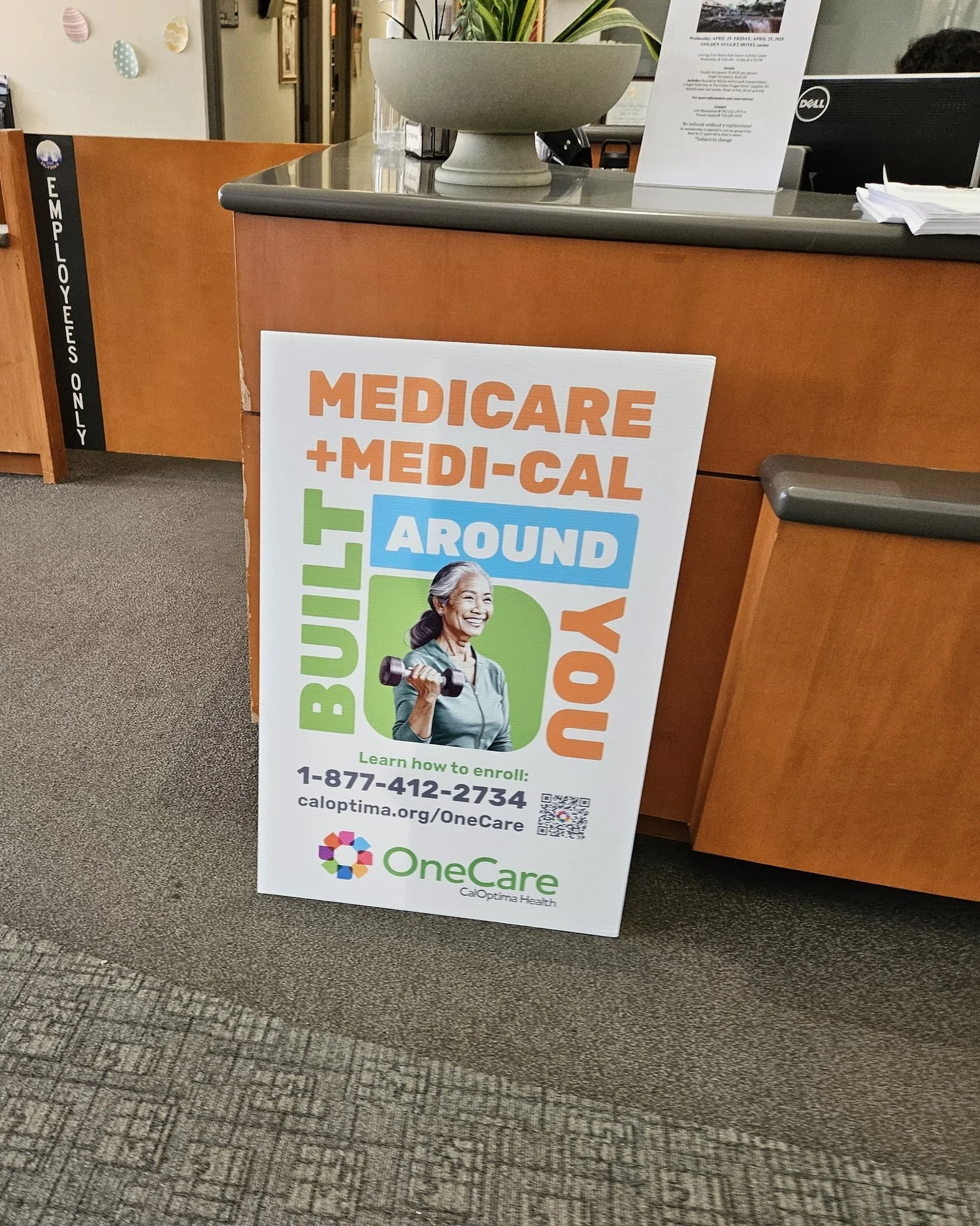 CalOptima OneCare Medicare + Medi-Cal "Built Around You" enrollment poster at a clinic front desk