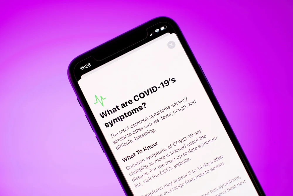 Phone screen showing COVID-19 symptom information