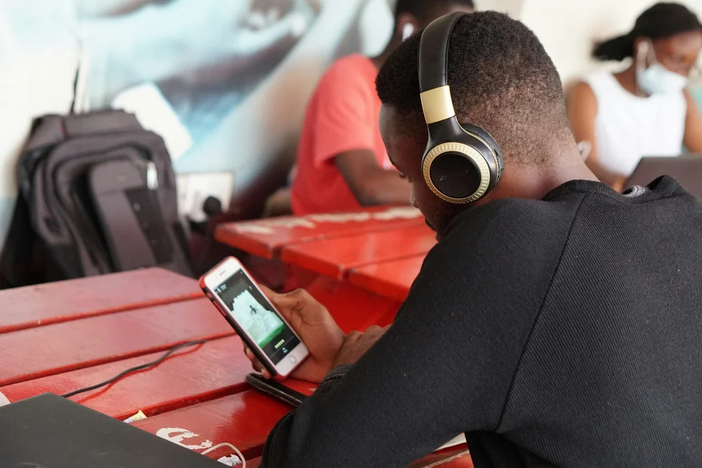 Teen wearing headphones outdoors