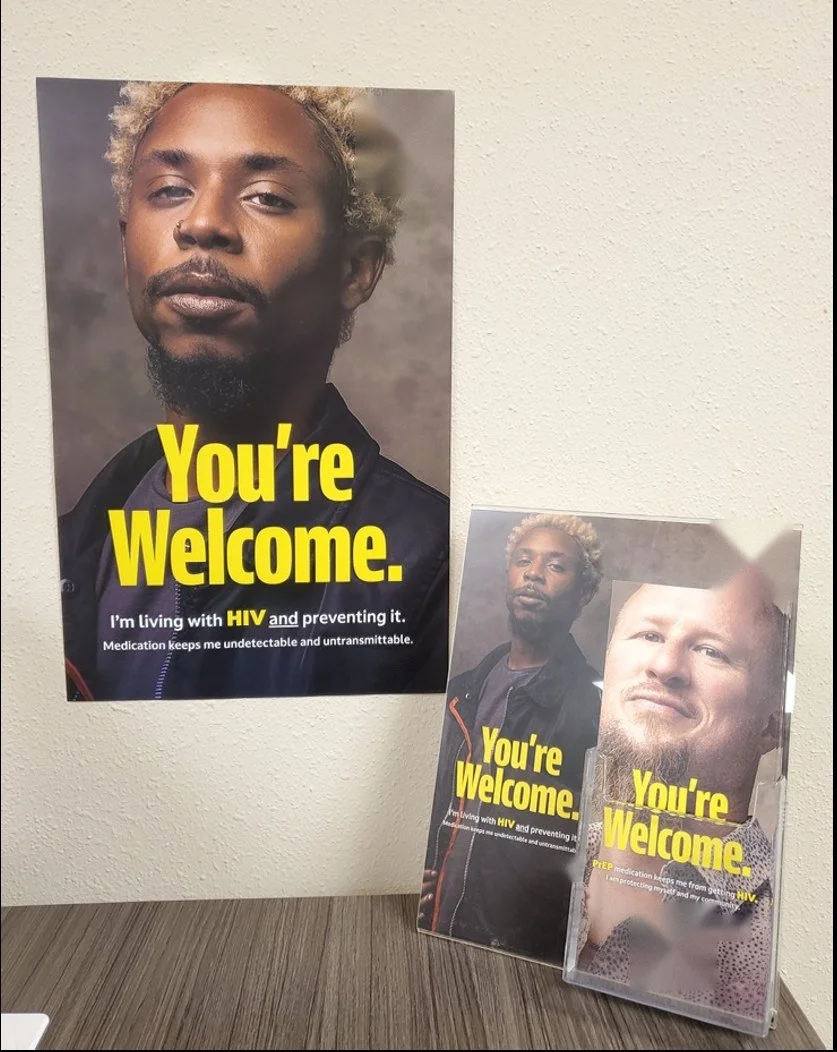 HIV prevention poster beside a rack of PrEP take-one cards