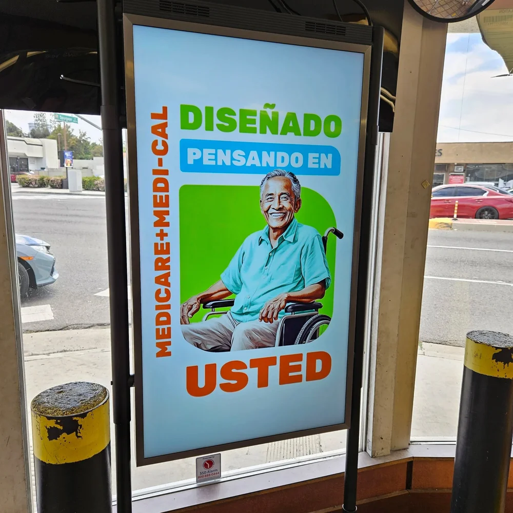 Spanish-language health plan ad on a street panel
