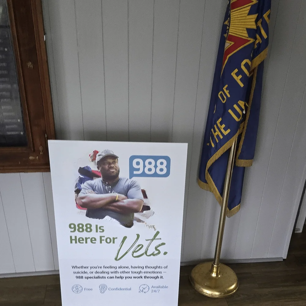 988 standee for veterans beside a flag inside a veterans post