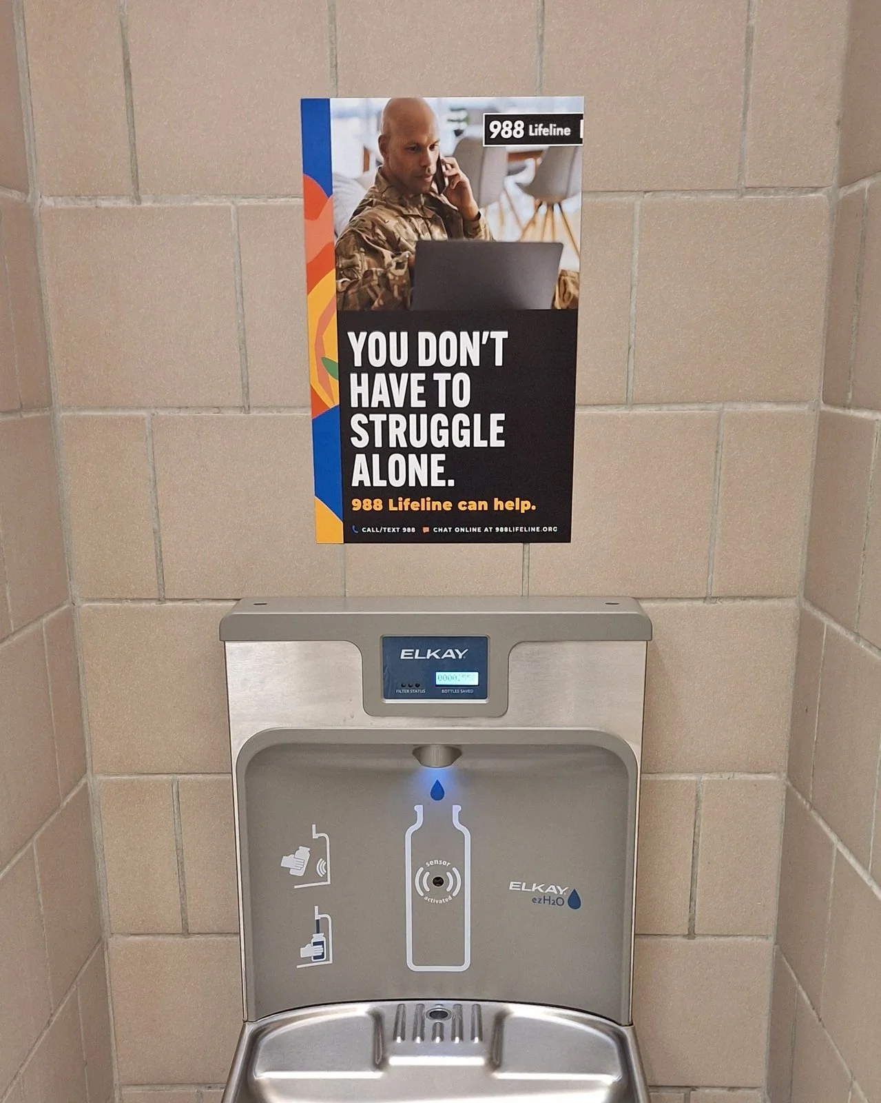 988 Lifeline poster for service members above a bottle-filling station