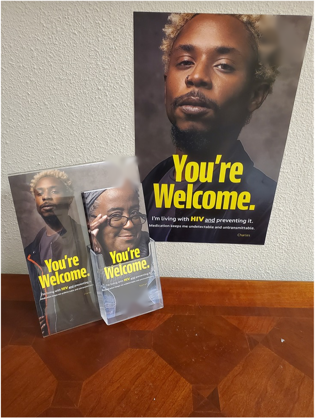 HIV prevention poster on a clinic wall above a matching brochure and take-one card holder