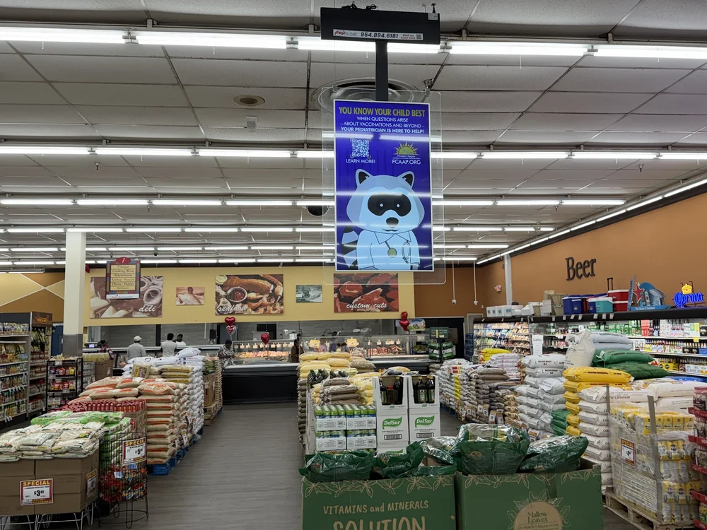 Digital screen hanging above a grocery store produce section