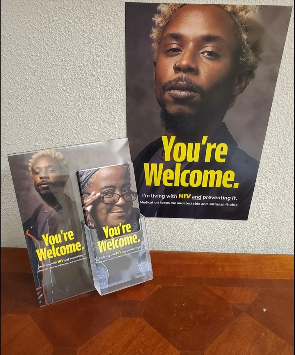 HIV prevention poster above an acrylic rack of take-one brochures